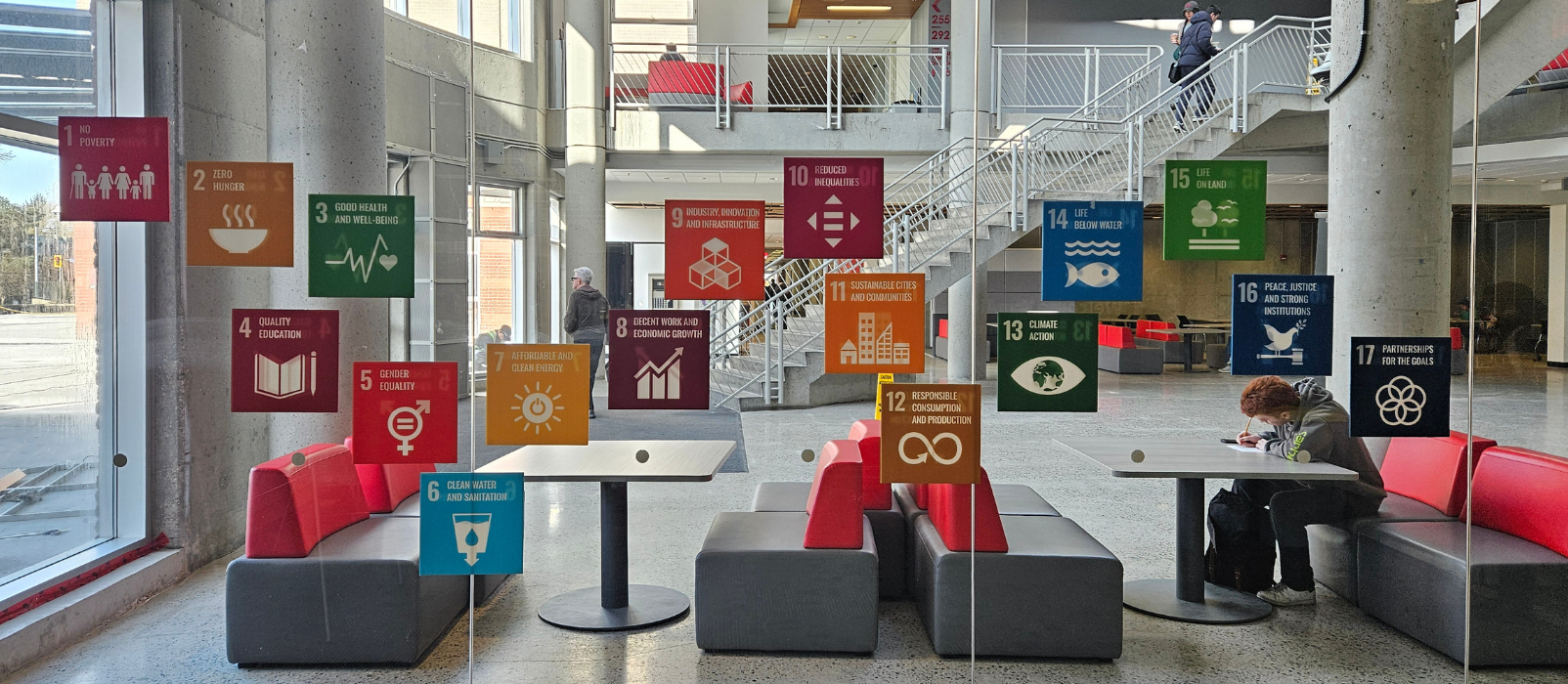 window with multiple colour squares posted along it 